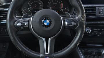 Peeling and cracked leather on a BMW M3 steering wheel at the 3 o'clock grip